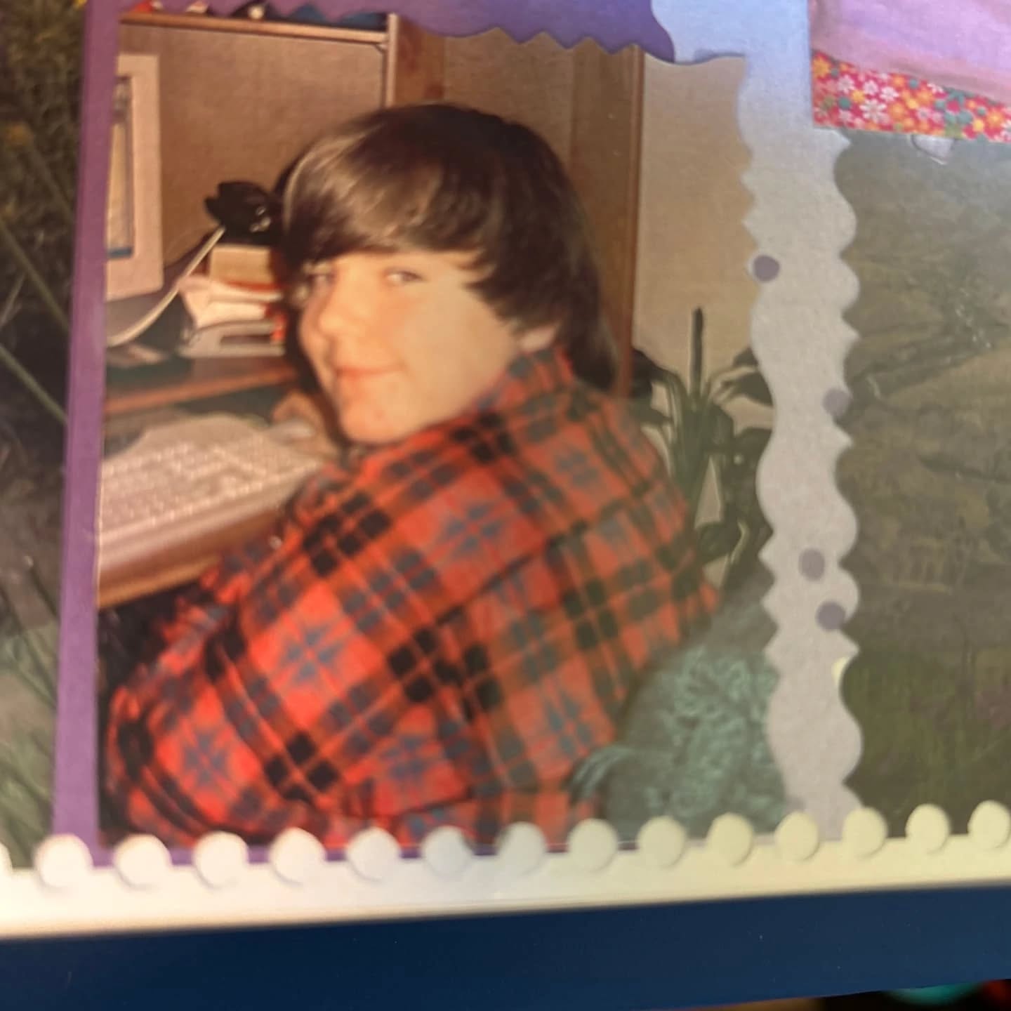 Stephen as a kid, sitting at a desk in front of a computer keyboard